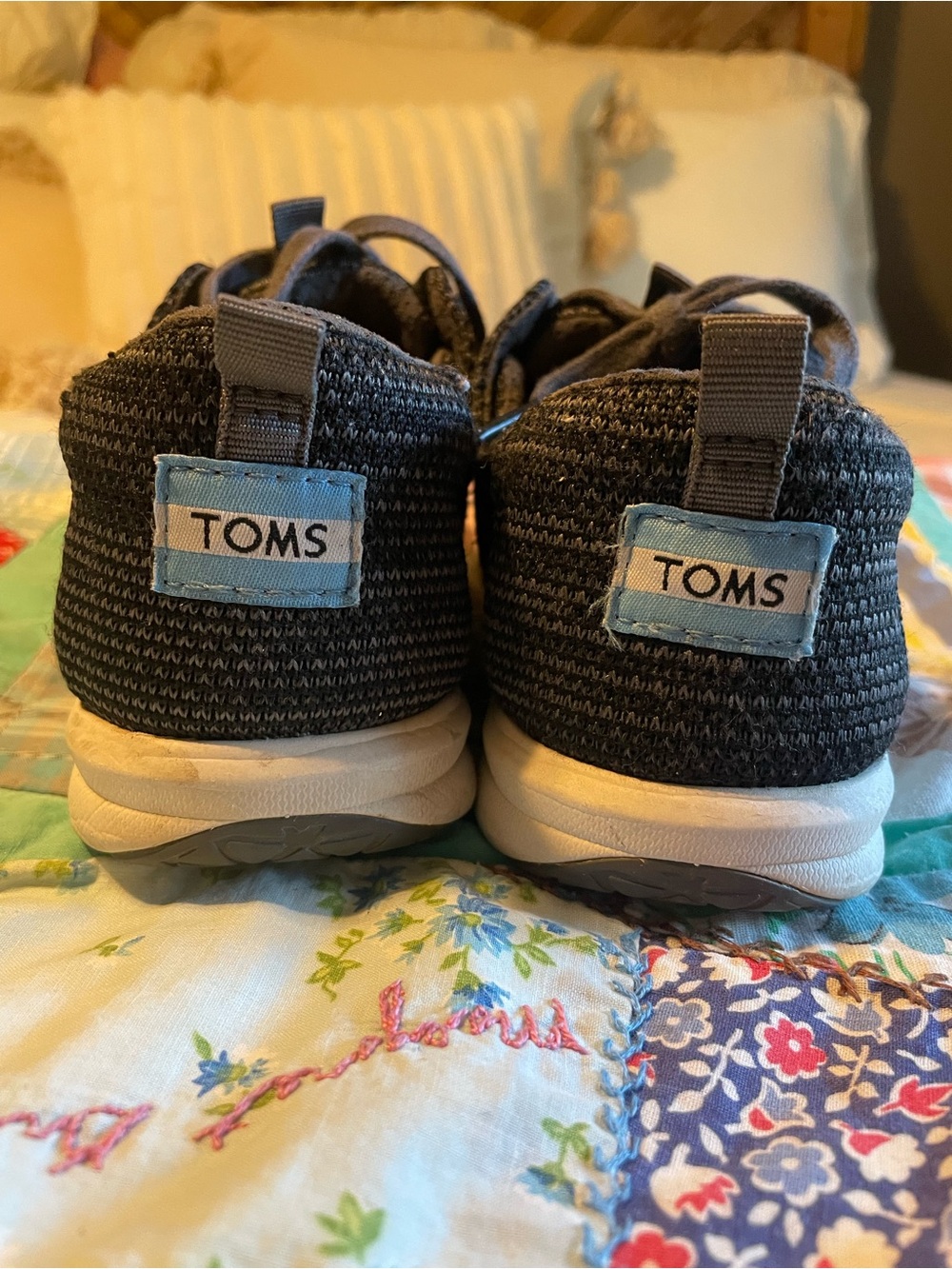 Toms Black Knit Slip-On Shoes with White Soles and Blue Logo Tabs